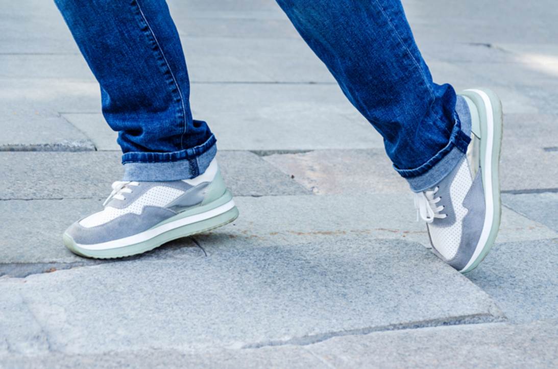 A person's legs and feet in jeans and sneakers
AI-generated content may be incorrect.